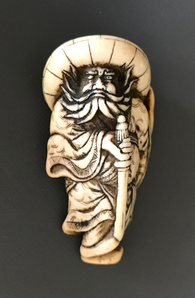 Ivory netsuke of Shoki holding his sword