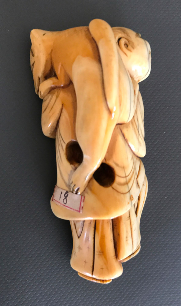 Ivory netsuke of a man dancing with a fox on his shoulder