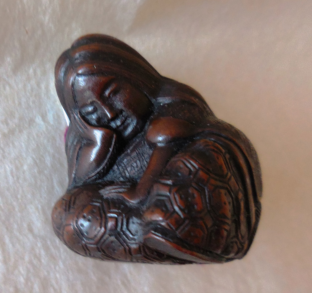 Wood netsuke of sleeping Shojo