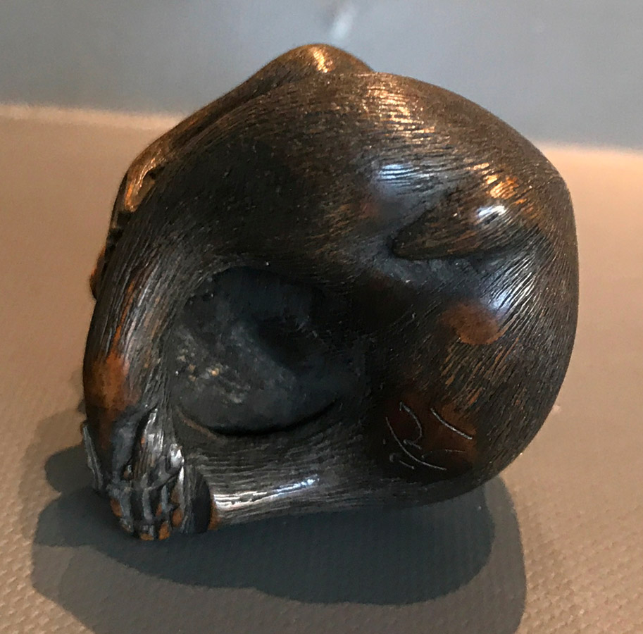 Wood netsuke of monkey picking a flea