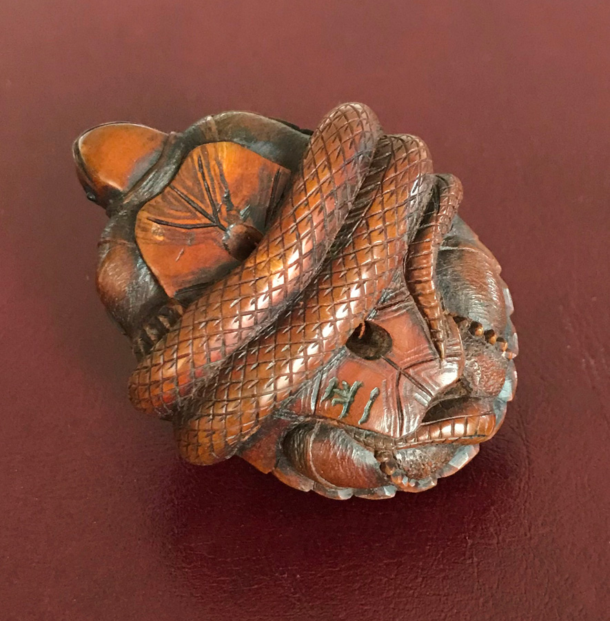 Netsuke of a snake wrapped around a tortoise