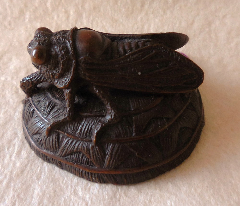 Netsuke of a fly on a hat